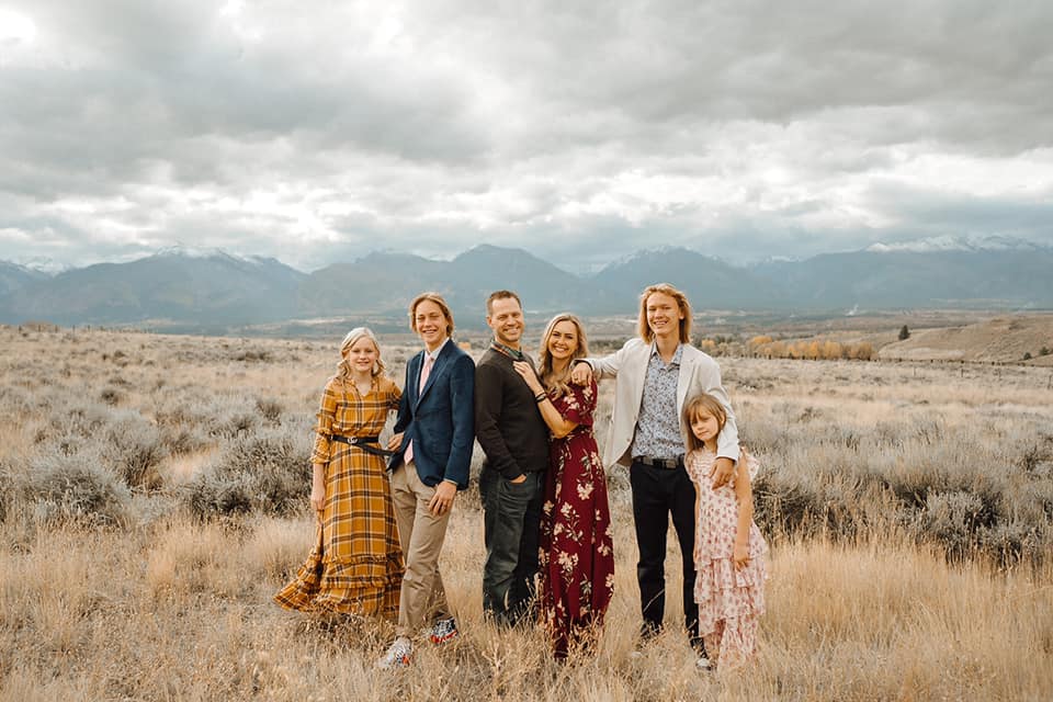 A family of six wearing dressy fall colors
